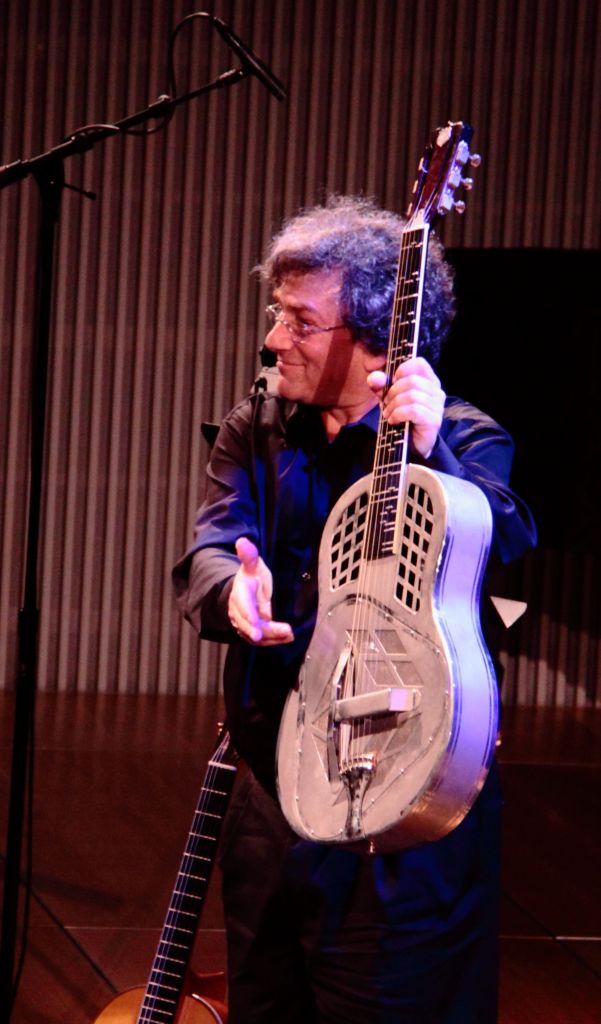 David Tanenbaum holding his National Steel Guitar as he acknowledges the warm applause